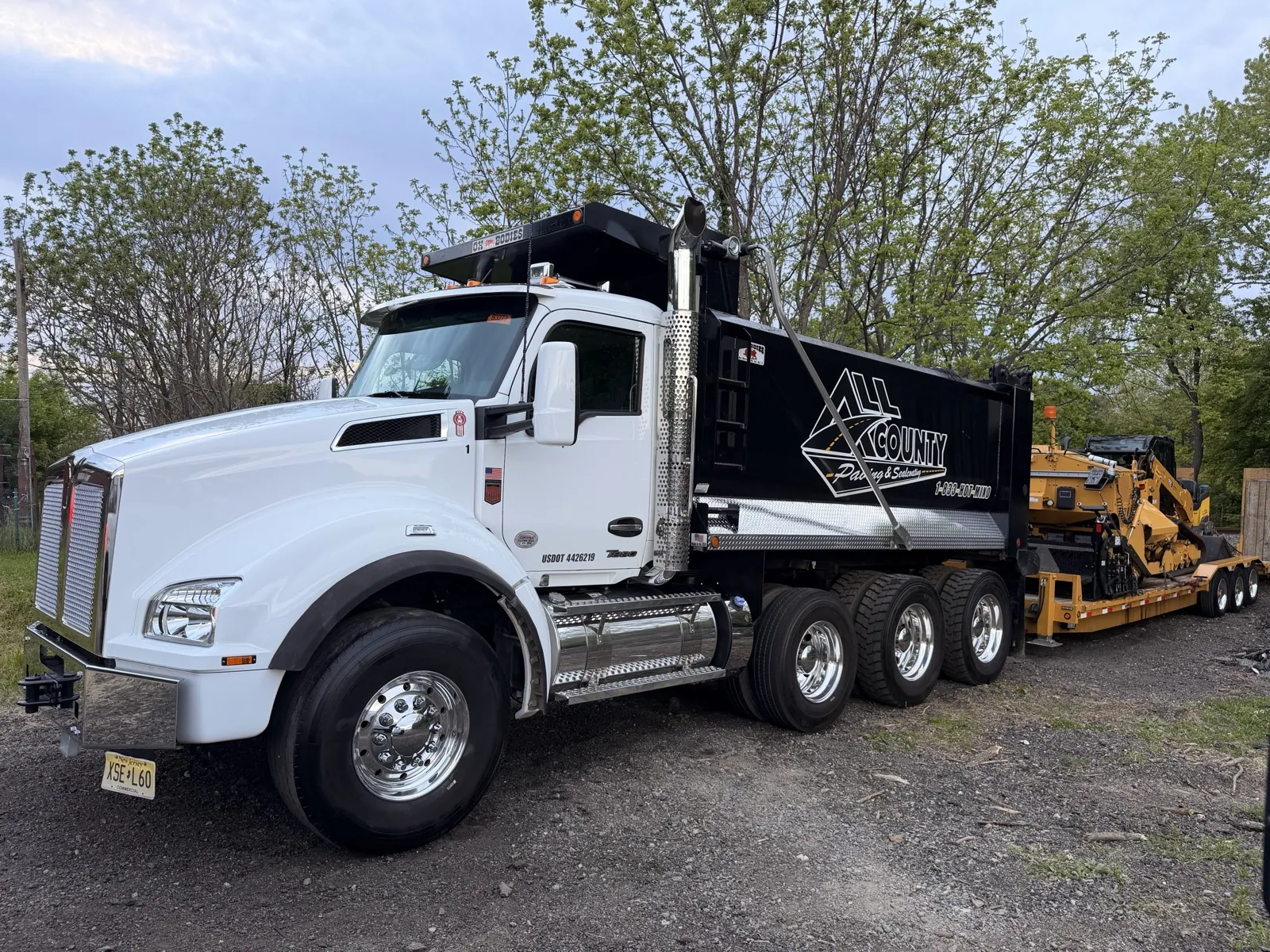 White All County Paving dump truck head-on on a paving job site