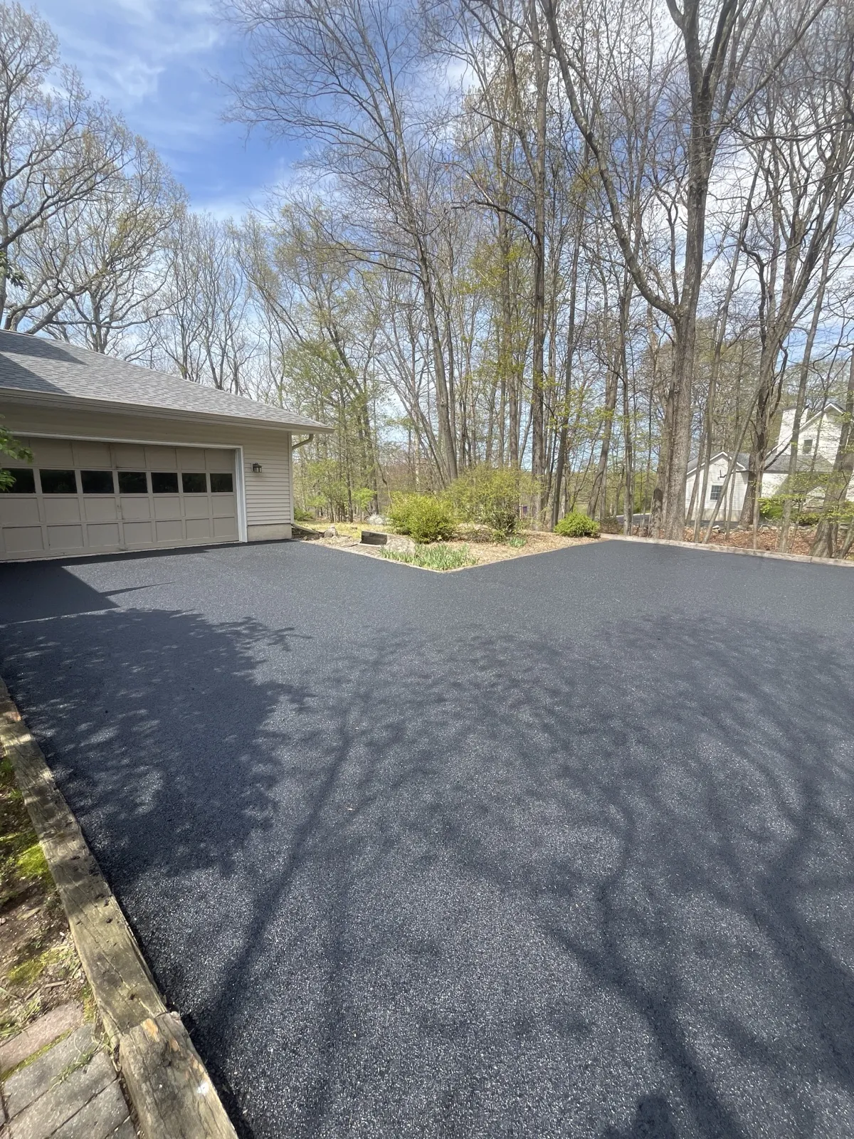 Asphalt driveway leading to a garage