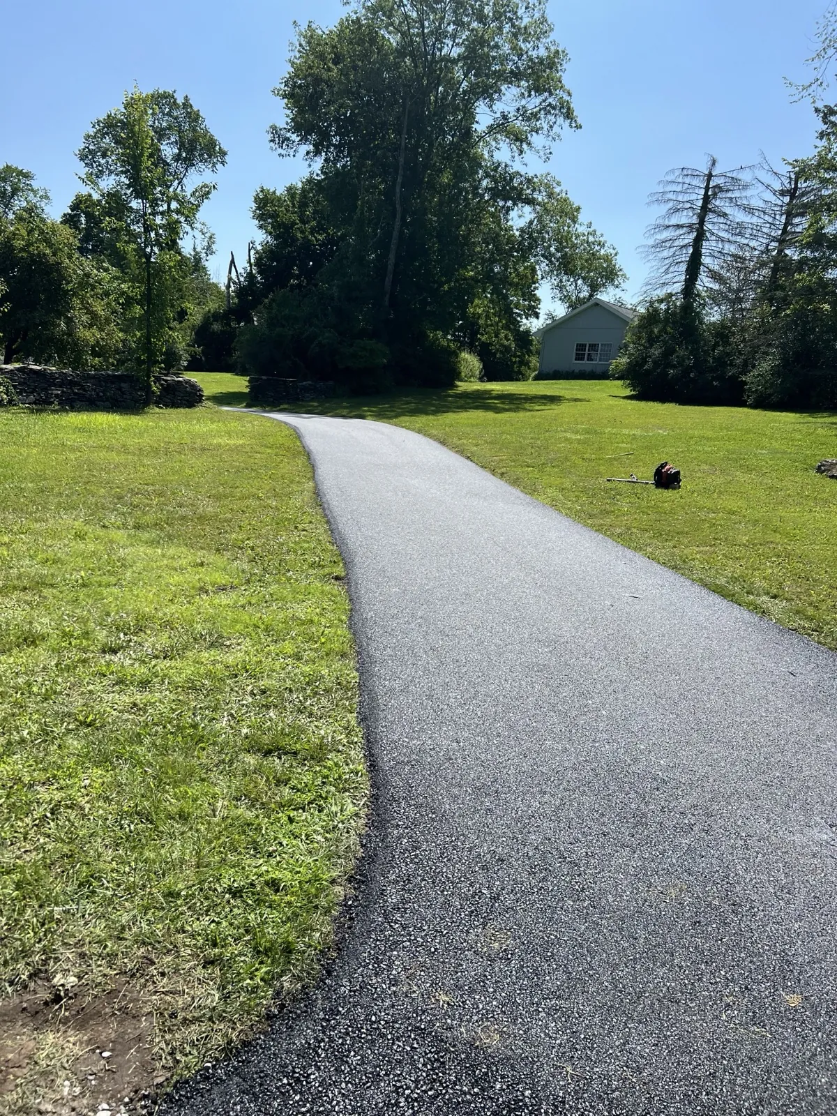 Driveway with hose in foreground, All County Paving NJ and PA