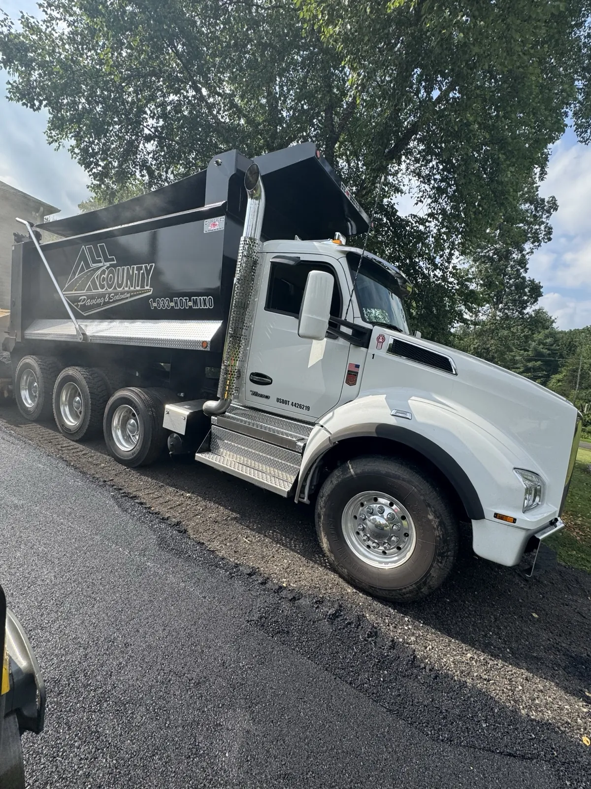 White All County Paving dump truck head-on with dramatic lighting