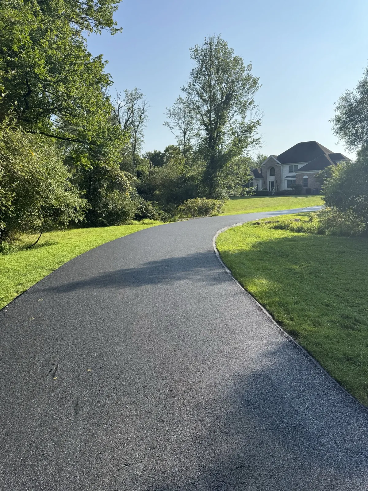 Clean driveway with mature landscape, All County Paving NJ and PA