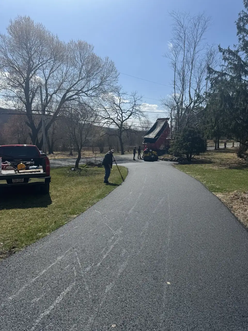 Driveway with red car at end, paved by All County Paving in New Jersey