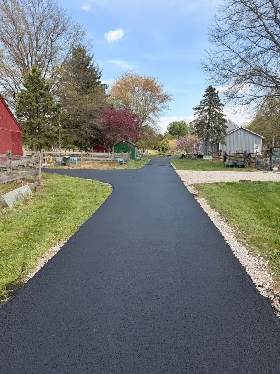 Forest driveway with stone retaining wall, paved by All County Paving in New Jersey
