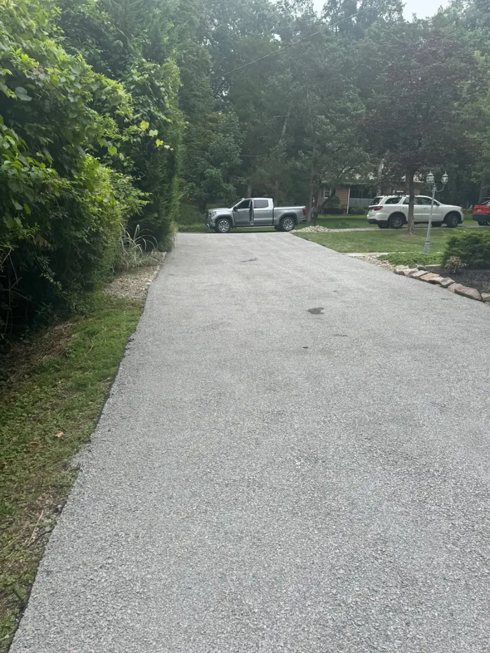 Driveway with mature trees both sides, paved by All County Paving in New Jersey