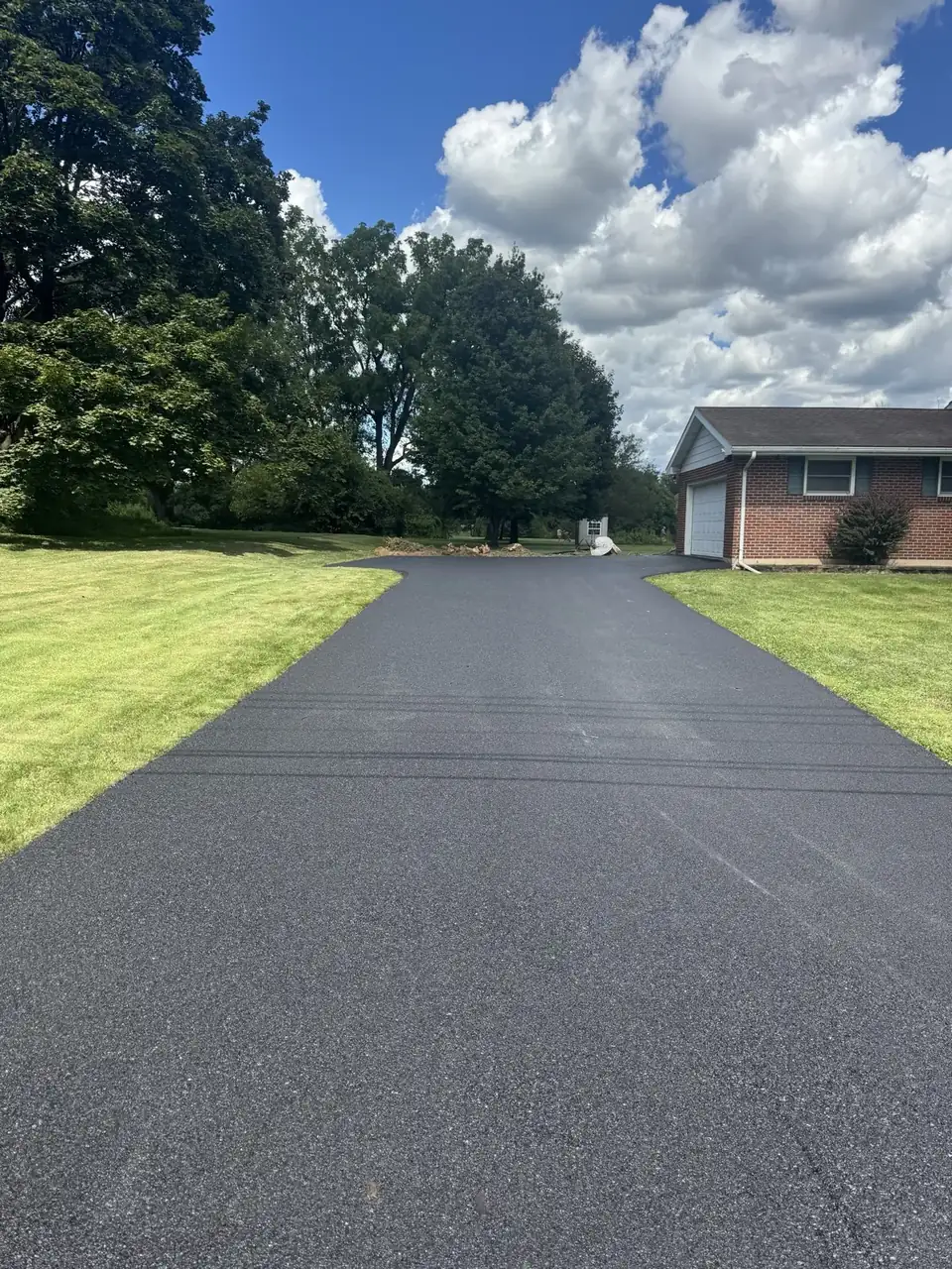 Driveway with home and red building, paved by All County Paving in New Jersey