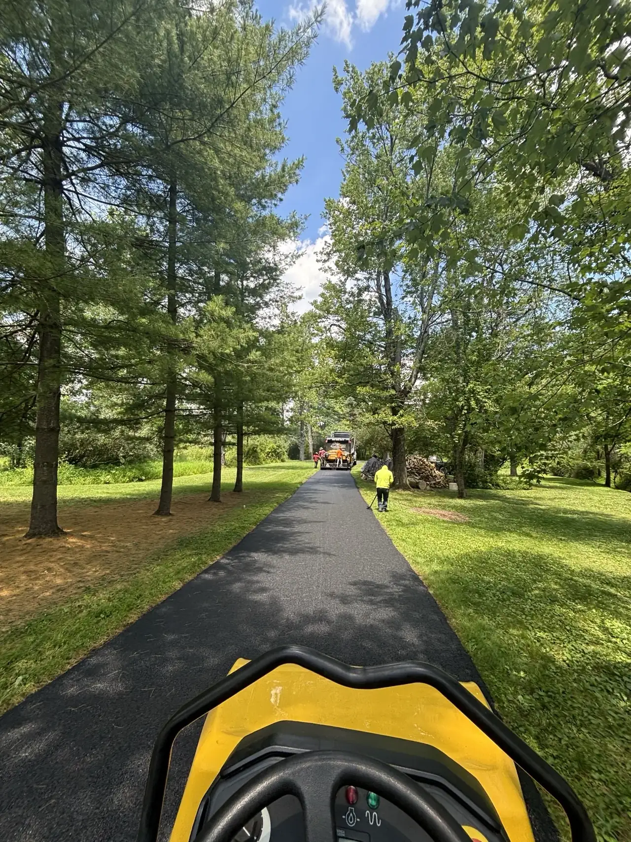 Long tree-lined asphalt driveway paved by All County Paving in New Jersey